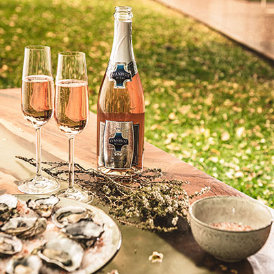 Ivanhoe Sparkling Maiden with oysters in outdoor grass setting