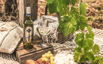 Bottle and glass of the The Archer 2019 in vineyard picnic setting